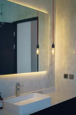 a bathroom with a sink and a mirror and lights at Villa Vantage 7 - Outstanding 3 BR Villa - Great Location! in Canggu