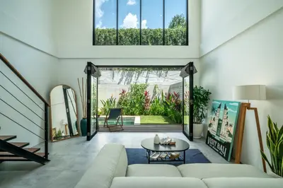 a living room with a couch and a table at Umalas Living Villa in Canggu