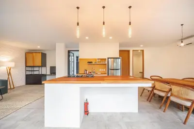a kitchen and dining room with a large island in the middle at Umalas Living Villa in Canggu