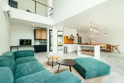 a living room with a green couch and a table at Umalas Living Villa in Canggu