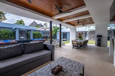 a living room with a couch and a table at Villa Aqua Seminyak in Seminyak