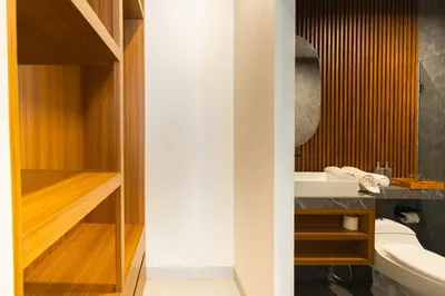 a bathroom with a sink and a mirror at Casa Wina Kuta by The Wina Resorts in Kuta