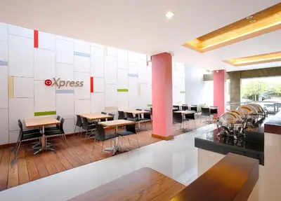 a dining area with tables and chairs in a restaurant at Amaris Hotel Dewi Sri - Bali in Legian