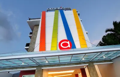 a colorful building with a sign on top of it at Amaris Hotel Dewi Sri - Bali in Legian