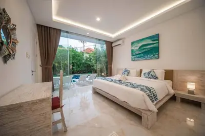 a bedroom with a large bed and a large window at Fantastic 3 Bed Villa, Walk to Beach, Sunny Pool in Seminyak