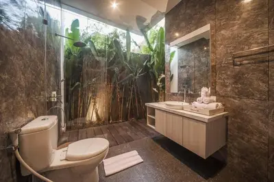 a bathroom with a shower and a toilet and a sink at Fantastic 3 Bed Villa, Walk to Beach, Sunny Pool in Seminyak