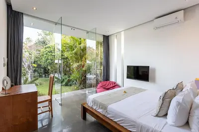 a bedroom with a bed and a large window at Villa Bahia by Optimum Bali Villas in Seminyak