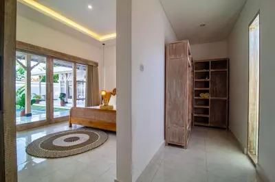 a hallway with a room with a bed and a window at Simple & Magical Villas PRAYA in Seminyak