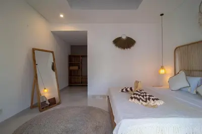 a bedroom with a bed with a mirror and a mirror at Simple & Magical Villas. Villa Sambali llI in Seminyak