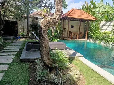 a statue of a snake by a swimming pool at Villa alula in Seminyak