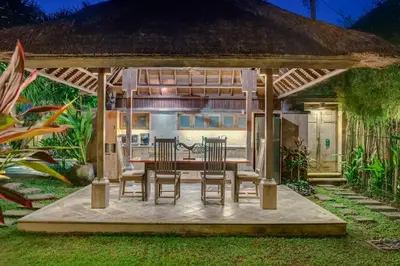 a table and chairs under a gazebo at The Tirta Naga Villas in Seminyak