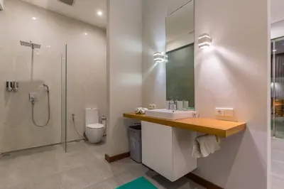 a bathroom with a sink and a shower and a toilet at Villa Serenity: modern design luxury 12m pool and BBQ in Seminyak