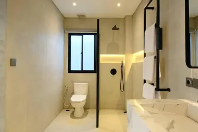 a bathroom with a toilet and a shower and a sink at Manresa Villa Bali 2 in Canggu