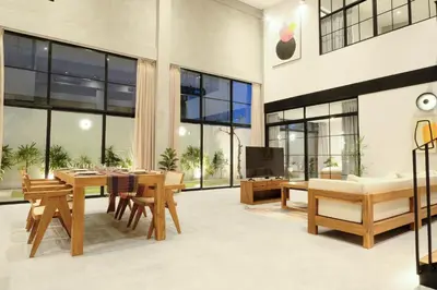 a living room with a table and chairs and a tv at Manresa Villa Bali 2 in Canggu