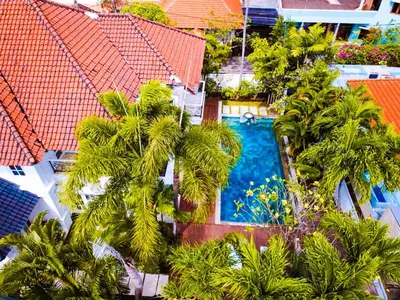 an aerial view of a hotel with palm trees and a swimming pool at Kencana Villa Seminyak in Seminyak