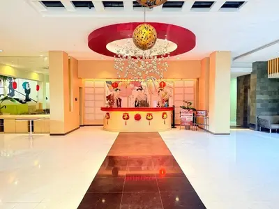 a large lobby with a chandelier in a building at Kimono Spa Hotel in Kuta