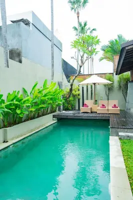 a swimming pool in the backyard of a house at The Kumpi Villas in Seminyak