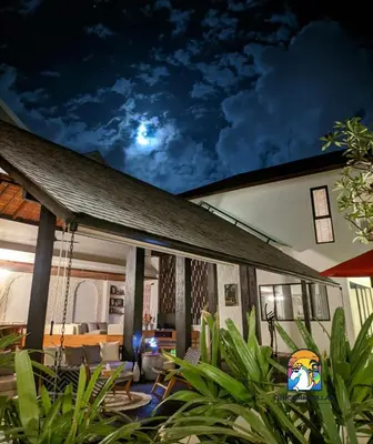 a house with a porch at night with a sky at Javine Villa - by Unicorn Villas Bali in Canggu