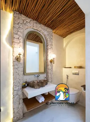 a bathroom with a sink and a mirror at Javine Villa - by Unicorn Villas Bali in Canggu
