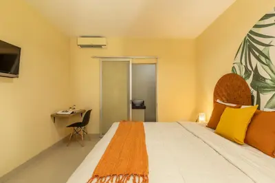 a bedroom with a bed and a desk at Cove Kanaya in Denpasar