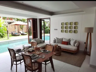 a living room with a table and a couch at T villa in Seminyak
