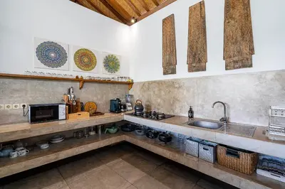 a kitchen with a sink and a microwave at Villa Aniri - Seminyak Villa - Walk to Beach & Cafés in Seminyak