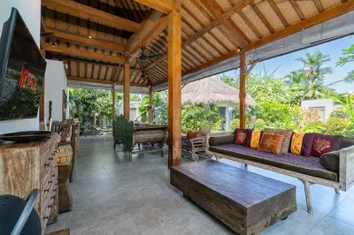 a living room with a couch and a table at Villa Aniri - Seminyak Villa - Walk to Beach & Cafés in Seminyak