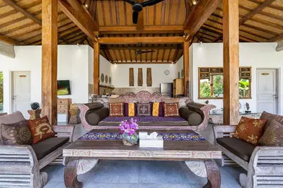 a living room with couches and a table at Villa Aniri - Seminyak Villa - Walk to Beach & Cafés in Seminyak