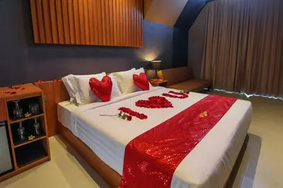 a bedroom with a bed with red decorations on it at Le Cielo Resort Umalas by Maviba in Canggu