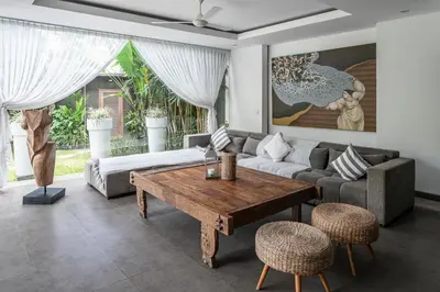 a living room with a couch and a table at Villa Alopa 1 in Seminyak