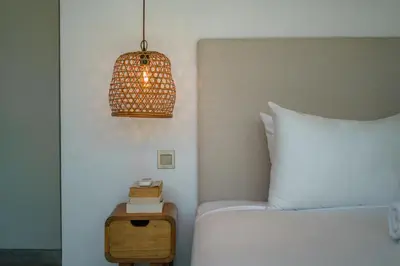 a bedroom with a bed and a table with a lamp at Bali Townhouse 1 - Amazing 2BR Villa w/pool - Perfect Location in Canggu