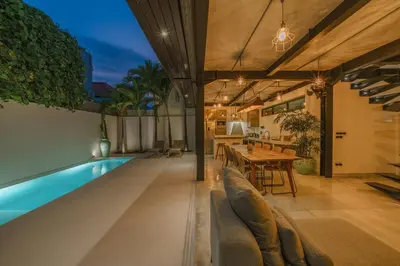 an indoor swimming pool with a table and a dining room at Bali Townhouse 1 - Amazing 2BR Villa w/pool - Perfect Location in Canggu