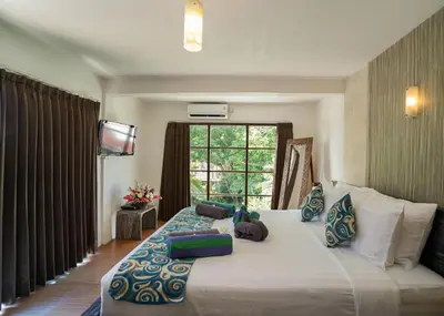 a bedroom with a large bed and a window at Villa Indalia in Seminyak