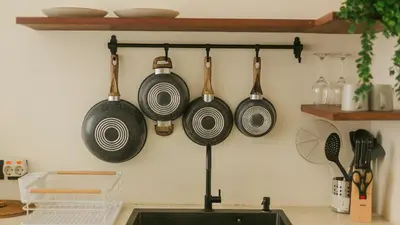 a kitchen with pots and pans hanging on a wall at Seffalas Villa by Betterplace in Canggu