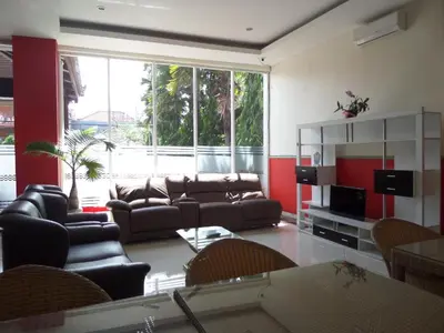 a living room with a couch and a table at Alkyfa Hotel Bali in Denpasar