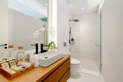 a bathroom with a sink and a toilet and a shower at The Oasis Smart Villa in Canggu