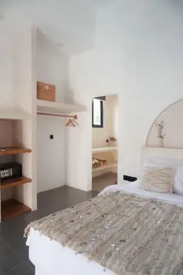 a white bedroom with a bed and a mirror at Stella Moon Villa Bali in Kerobokan