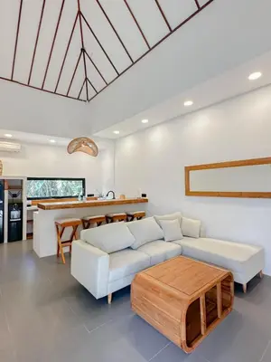 a living room with a white couch and a table at Stella Moon Villa Bali in Kerobokan