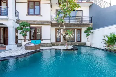 a swimming pool in front of a house at Villa Sky View - Seminyak in Seminyak