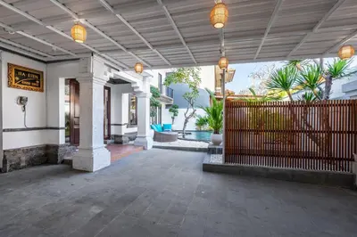 a porch of a house with a fence and lights at Villa Sky View - Seminyak in Seminyak