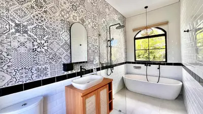 a bathroom with a tub and a sink and a bath tub at The BALIem Villa in Jimbaran
