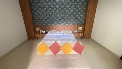 a bedroom with a bed with colorful triangles on it at The BALIem Villa in Jimbaran