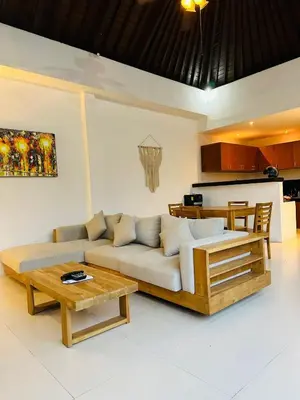 a living room with a couch and a coffee table at De'Huta Villa in Canggu