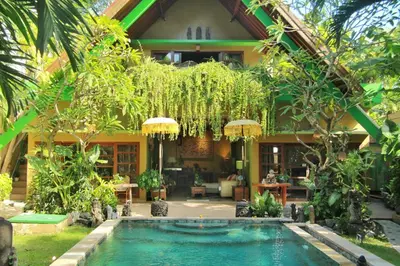 a house with a swimming pool in the yard at The Chand Villa - A Hidden Gem in Petitenget in Seminyak