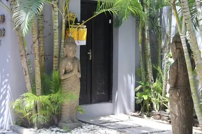 a statue of a man standing in front of a door at Yoga Villa in Seminyak