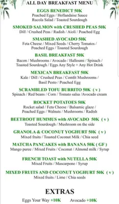 a white menu with green writing on it at Selog Villa 4 in Seminyak