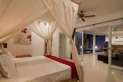 a bedroom with a bed and a living room at Selog Villa 4 in Seminyak