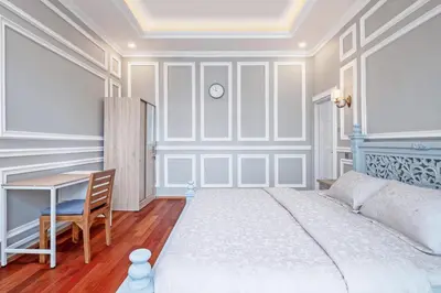 a bedroom with a bed and a desk and a table at Desa Residence Kerobokan in Kerobokan