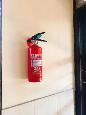 a red fire hydrant on the side of a wall at Villa Kinandari Bukit Jimbaran in Jimbaran