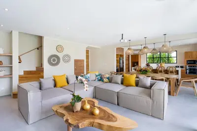 a living room with a couch and a table at Villa ElyOs Canggu by Nagisa Bali in Canggu